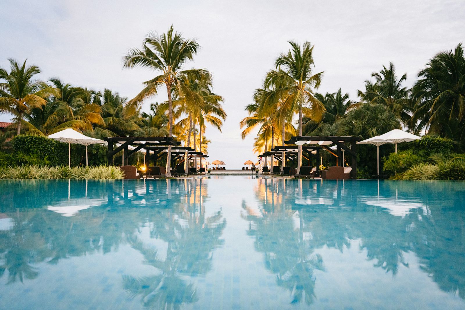An all-inclusive resort infinity pool at dusk
