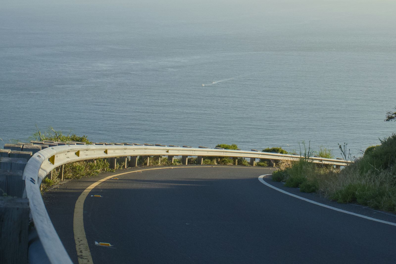 Scenic coastal road curving above the ocean