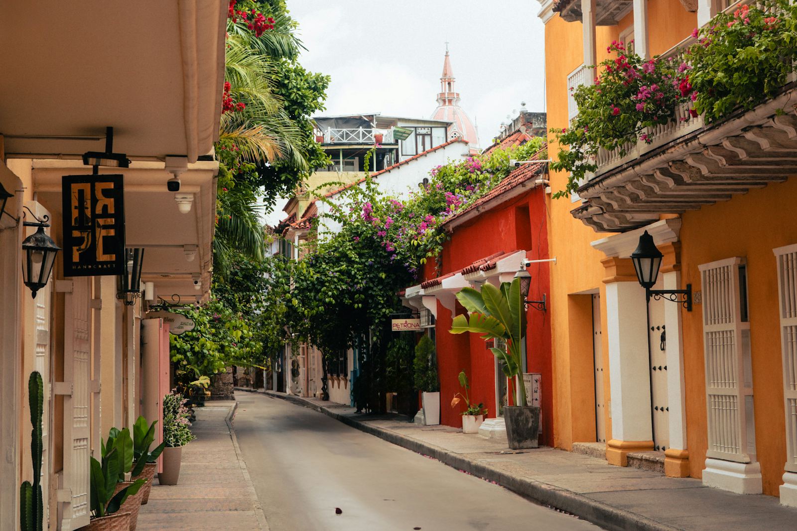 Colorful colonial street with flower-draped balconies in Cartagena, Colombia