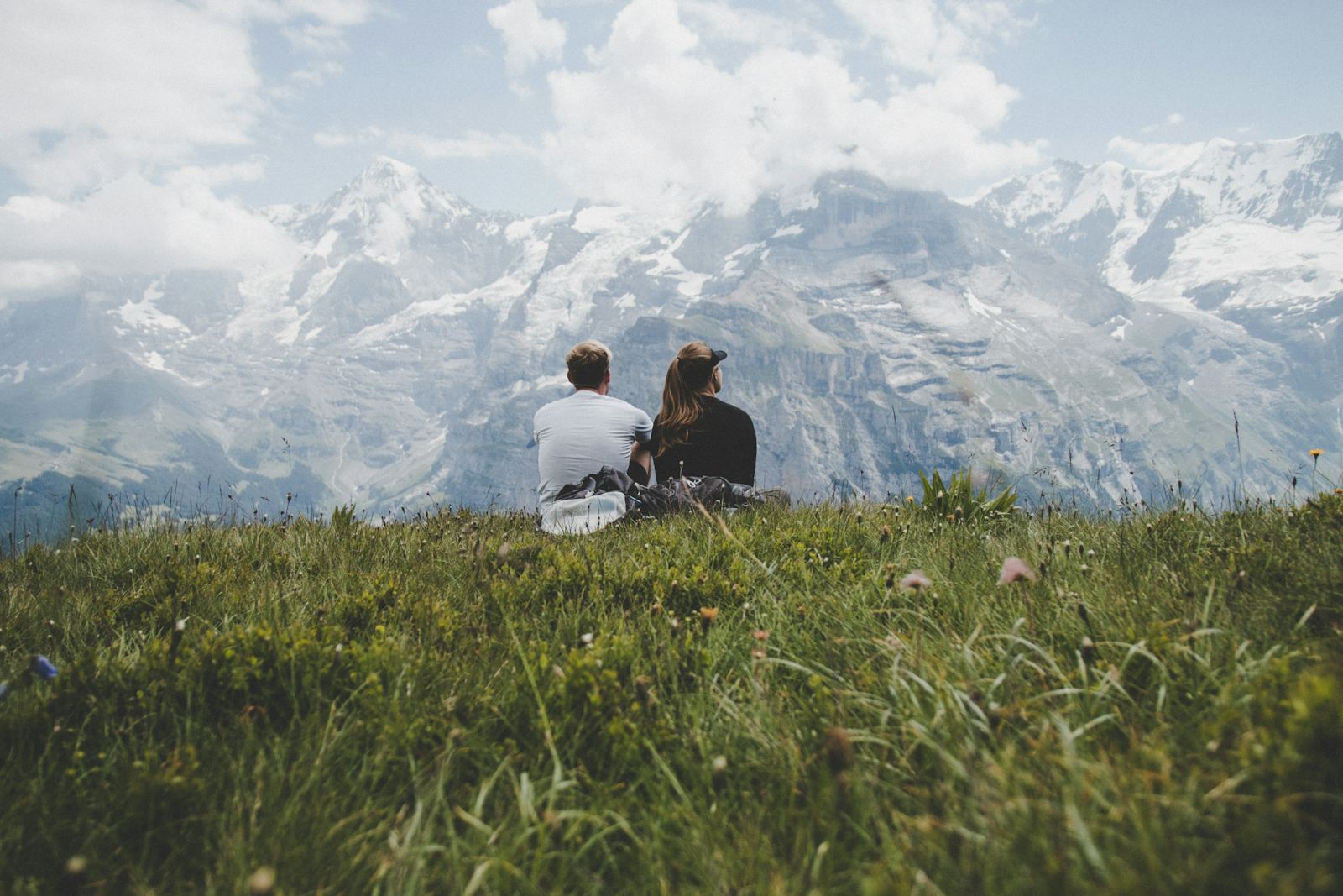A couple taking in a mountain view on their trip