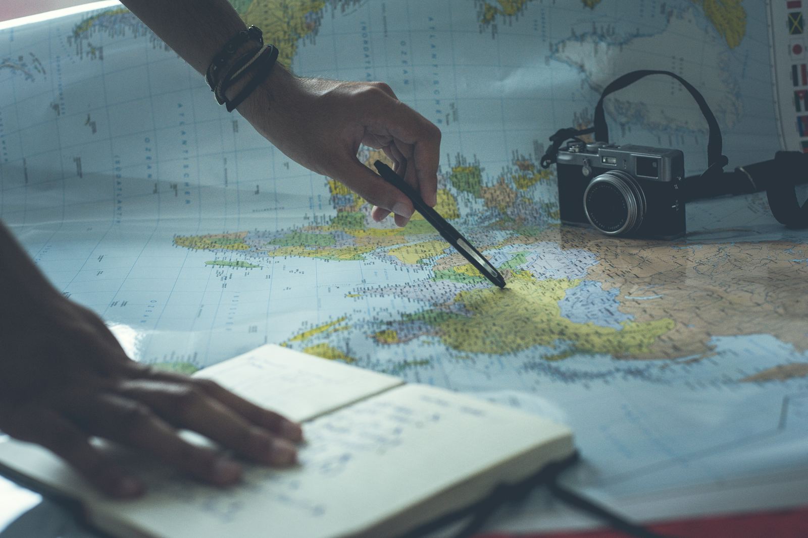 Planning a trip with a world map and notebook
